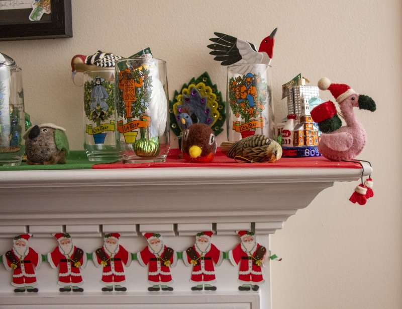 The mantel at Lisa and Tom Malone’s West Shore Drive home greets visitors with birds and vintage glassware.